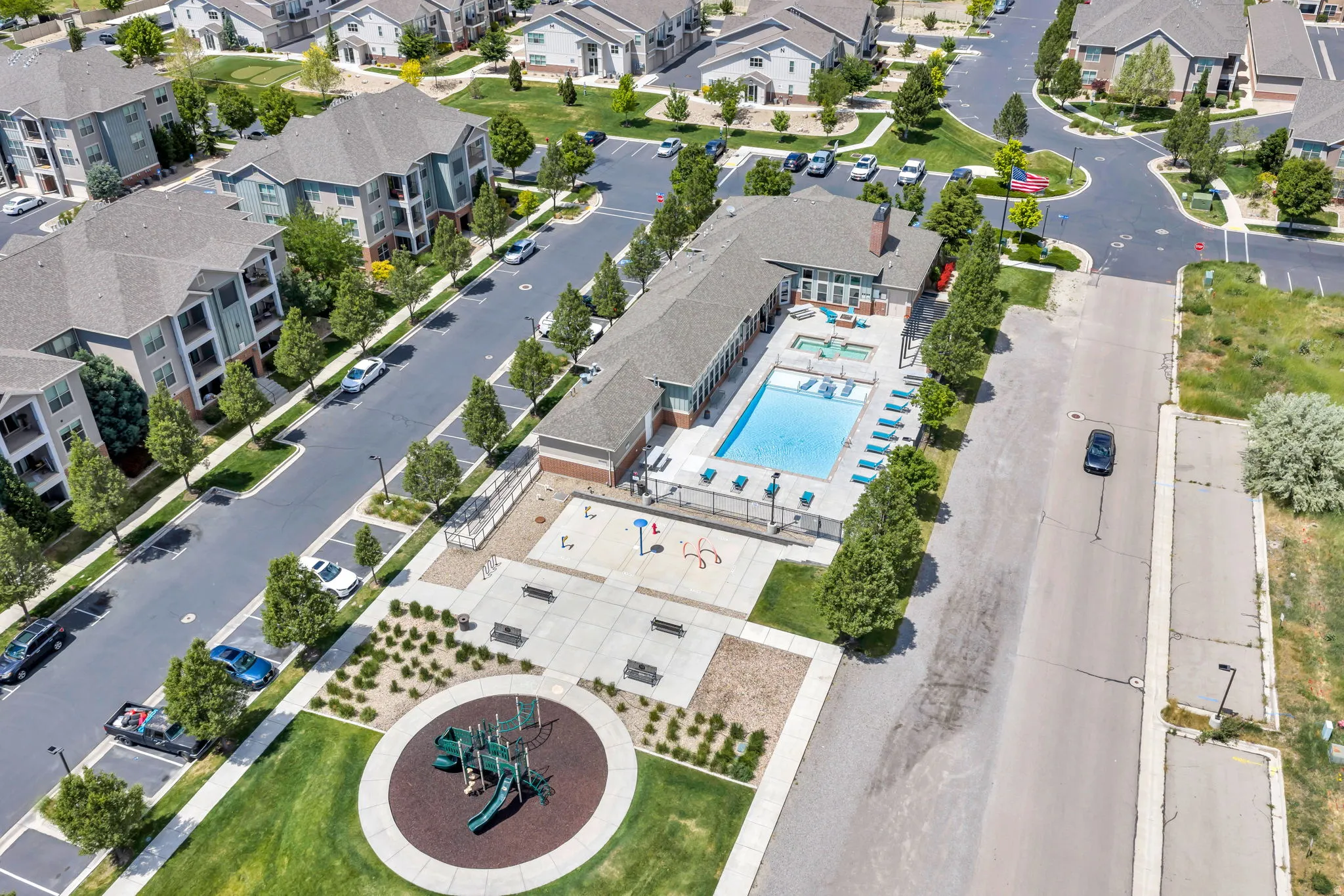 Community amenities featuring a central swimming pool, integrated spa, and surrounding lounge seating