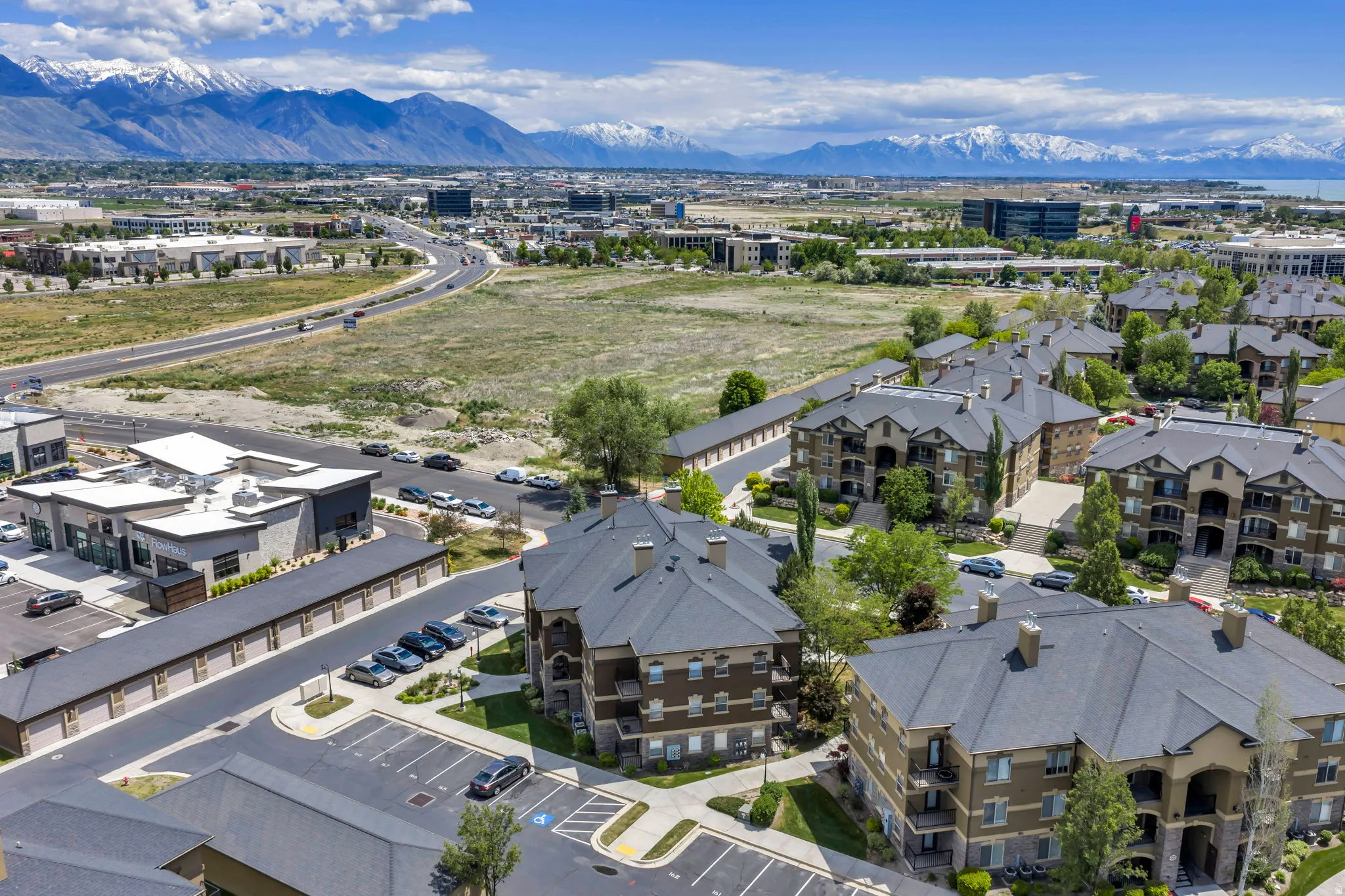 Community of multi-story buildings featuring balconies and dark shingle roofs