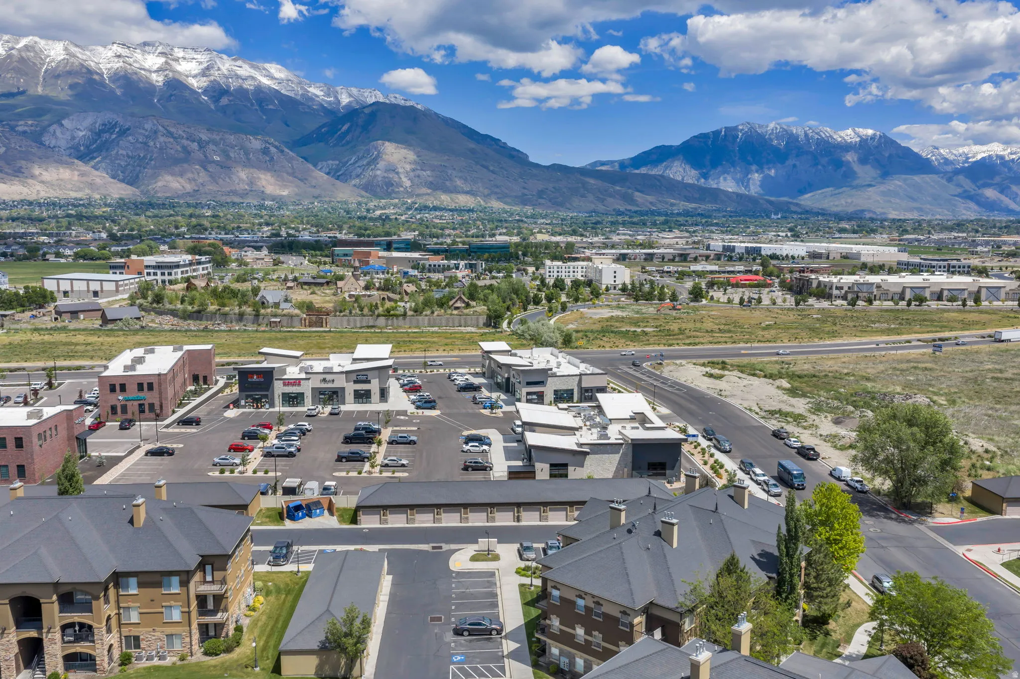 Expansive residential and commercial development situated at the base of snow-capped mountains