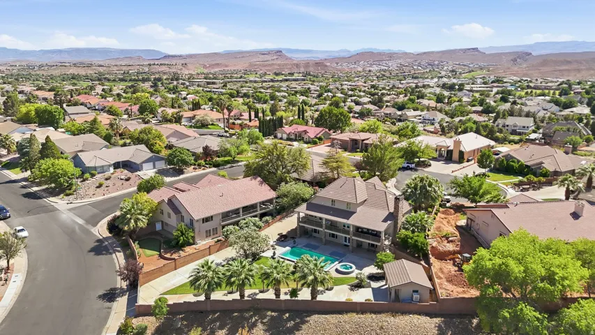 Multi-story property with a two-tier balcony overlooking a built-in swimming pool and integrated spa