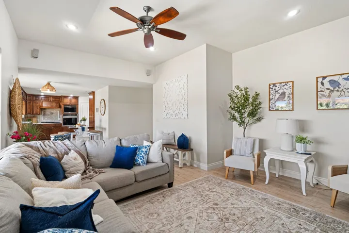 Spacious living area featuring wood-finish flooring, recessed lighting, and a ceiling fan