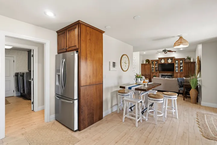 Stainless steel refrigerator integrated into wood cabinetry