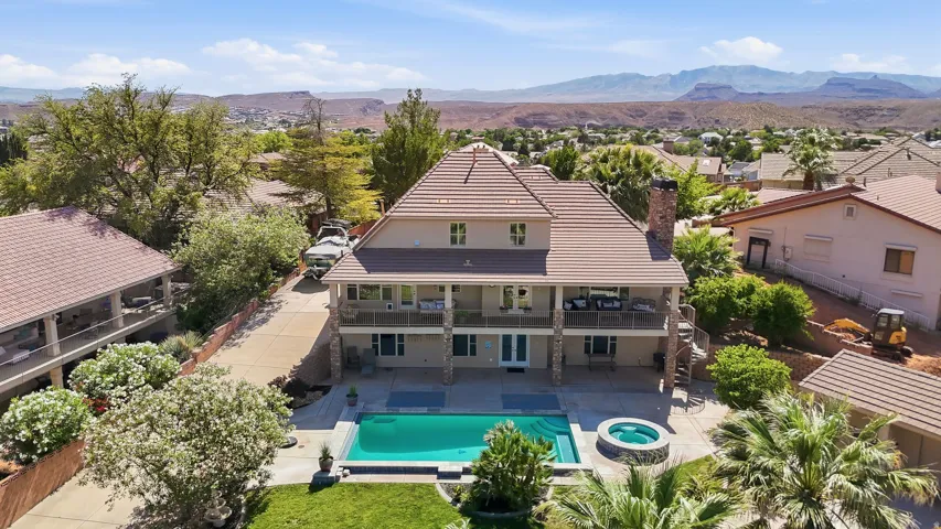Multi-level residence featuring a large swimming pool, integrated spa, and expansive patio