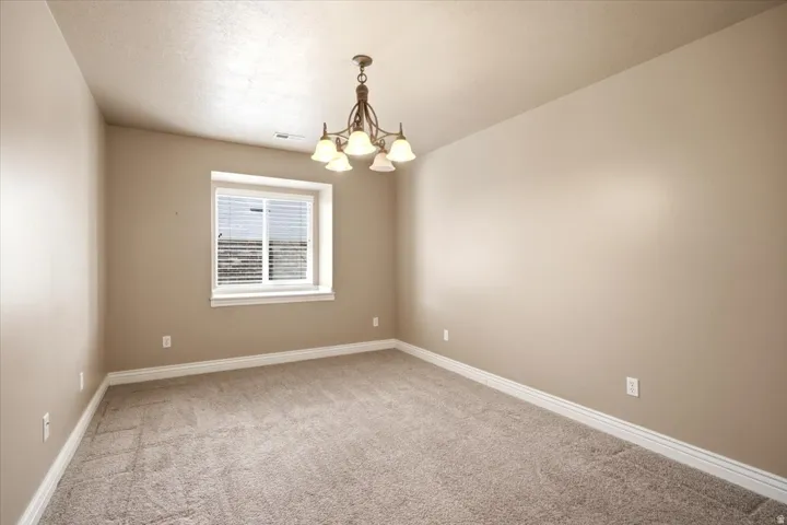 Neutral tone walls with white trim and a textured ceiling