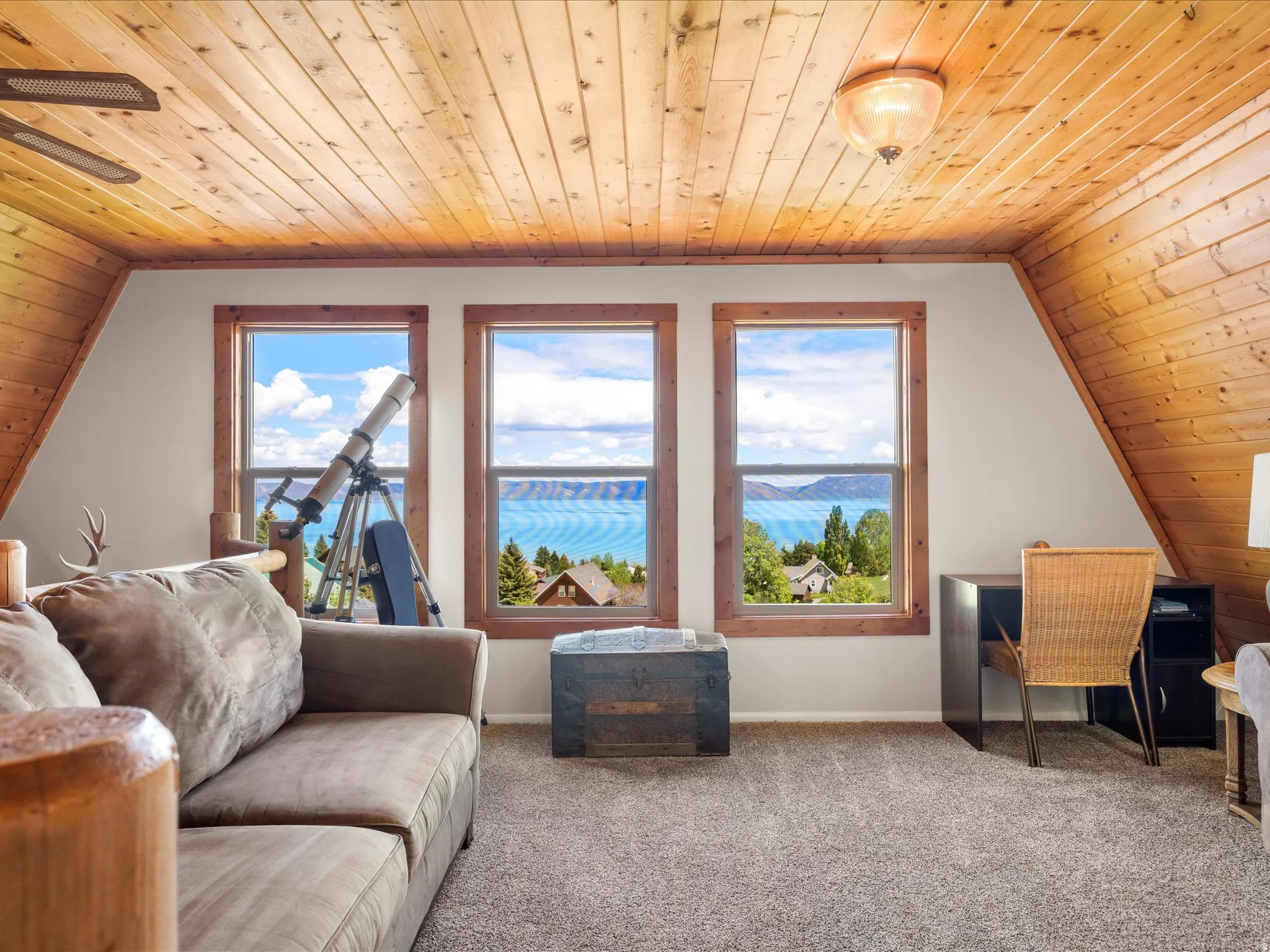 Wood-paneled ceilings with exposed beams and a flush-mount light fixture