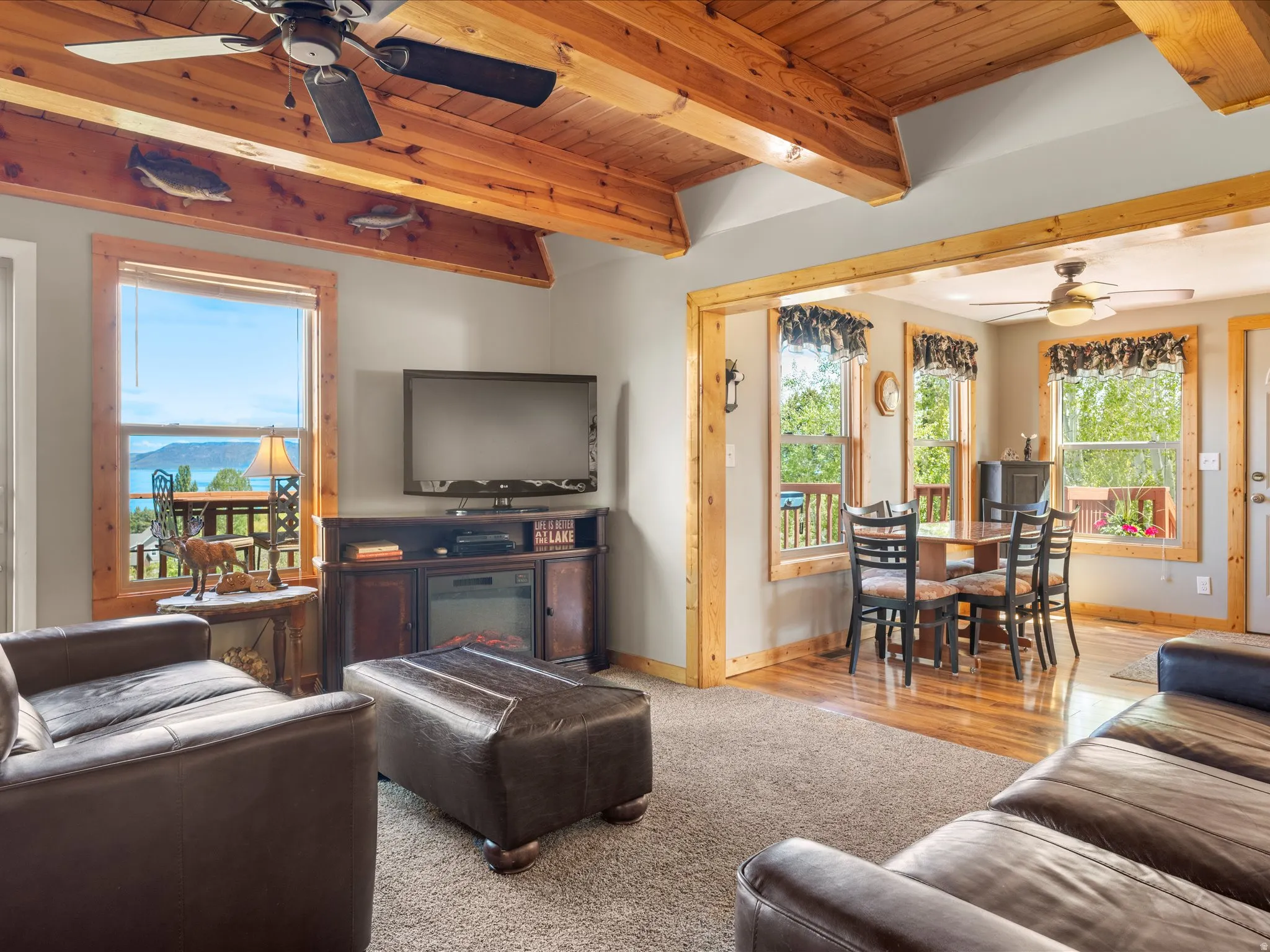 Living area featuring exposed wood beam ceilings and a scenic water backdrop