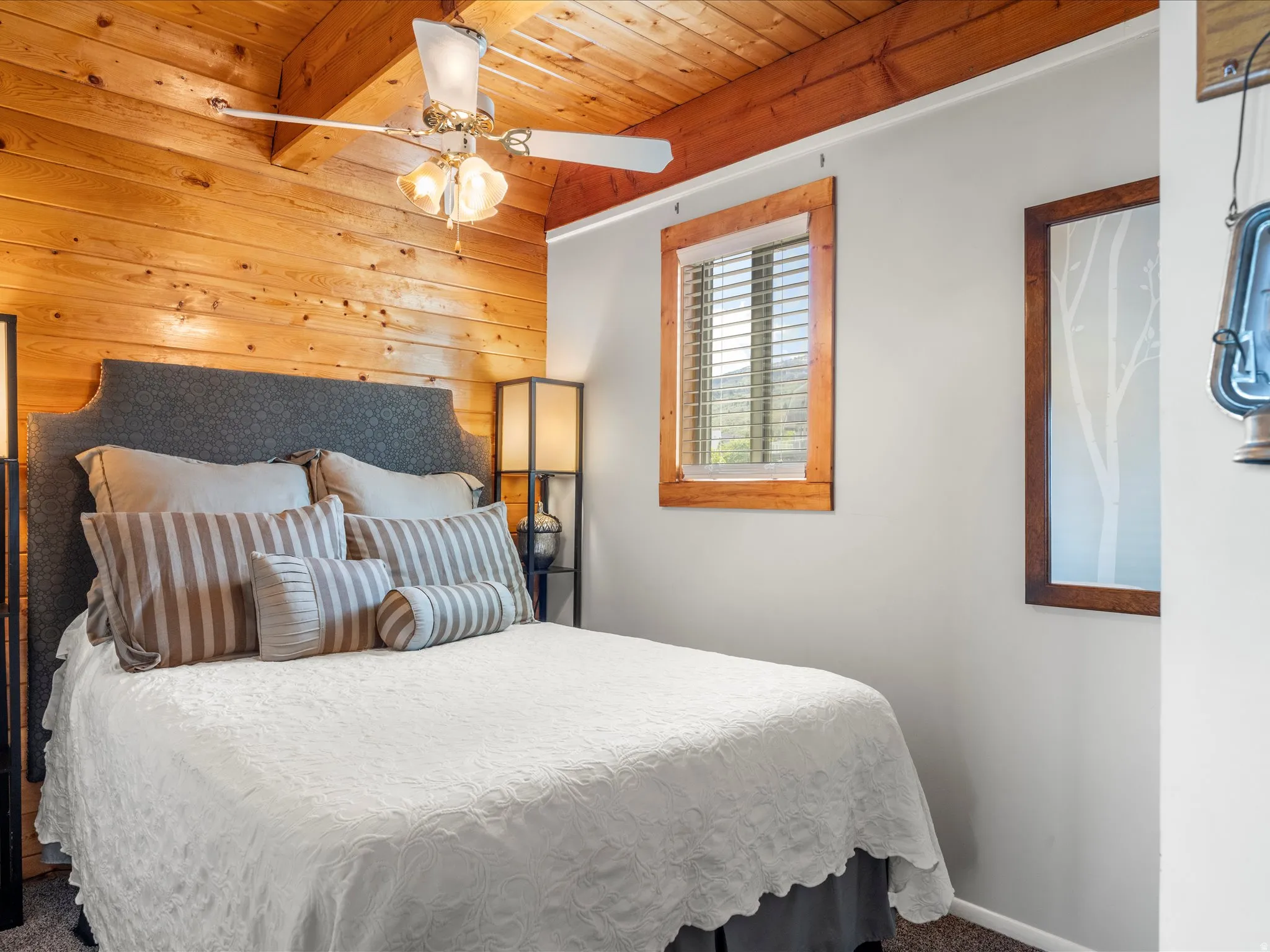 Wood-paneled accent wall with a vaulted wood-finish ceiling