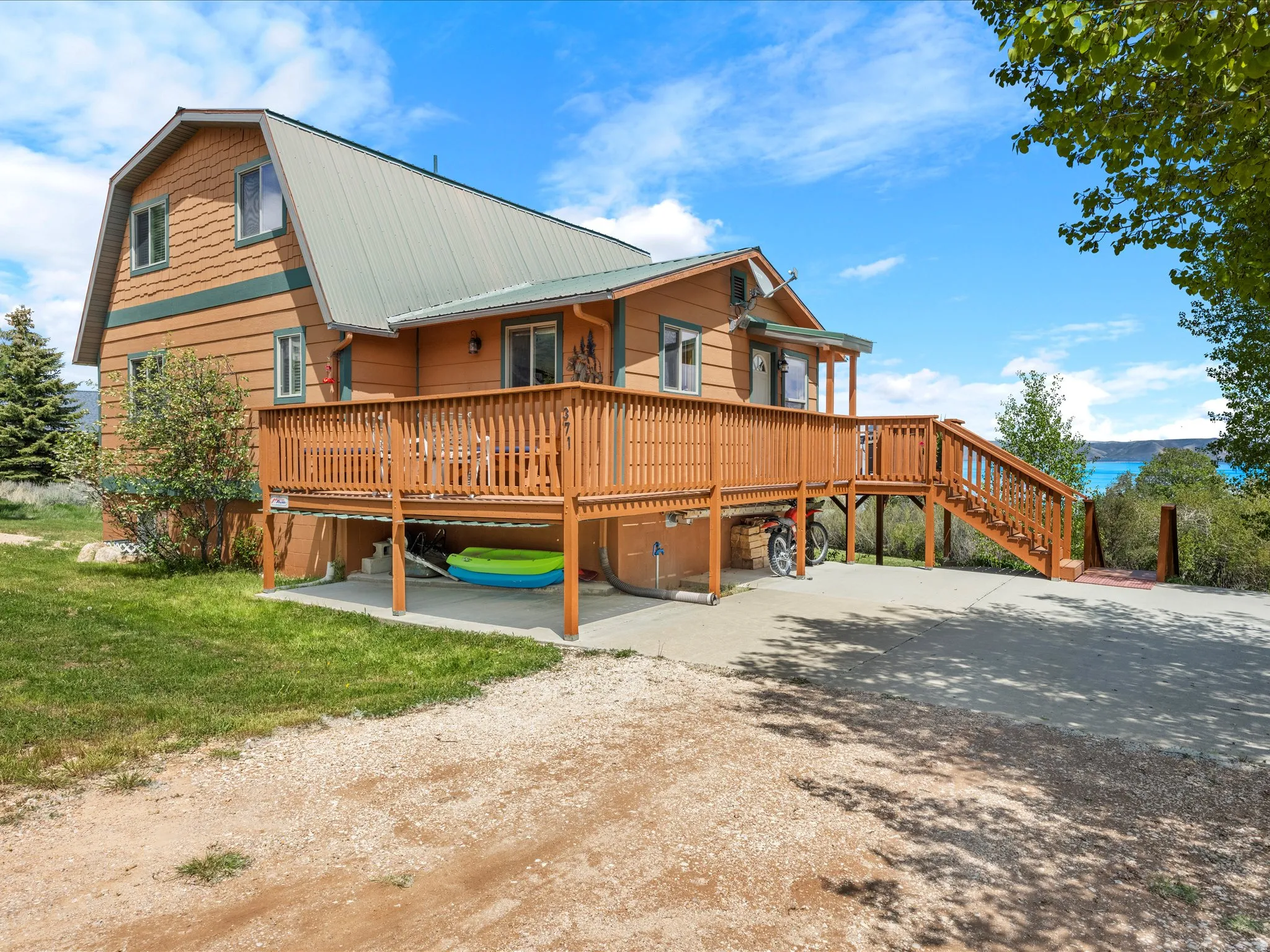Rustic style residence featuring a prominent wood deck and a metal roof