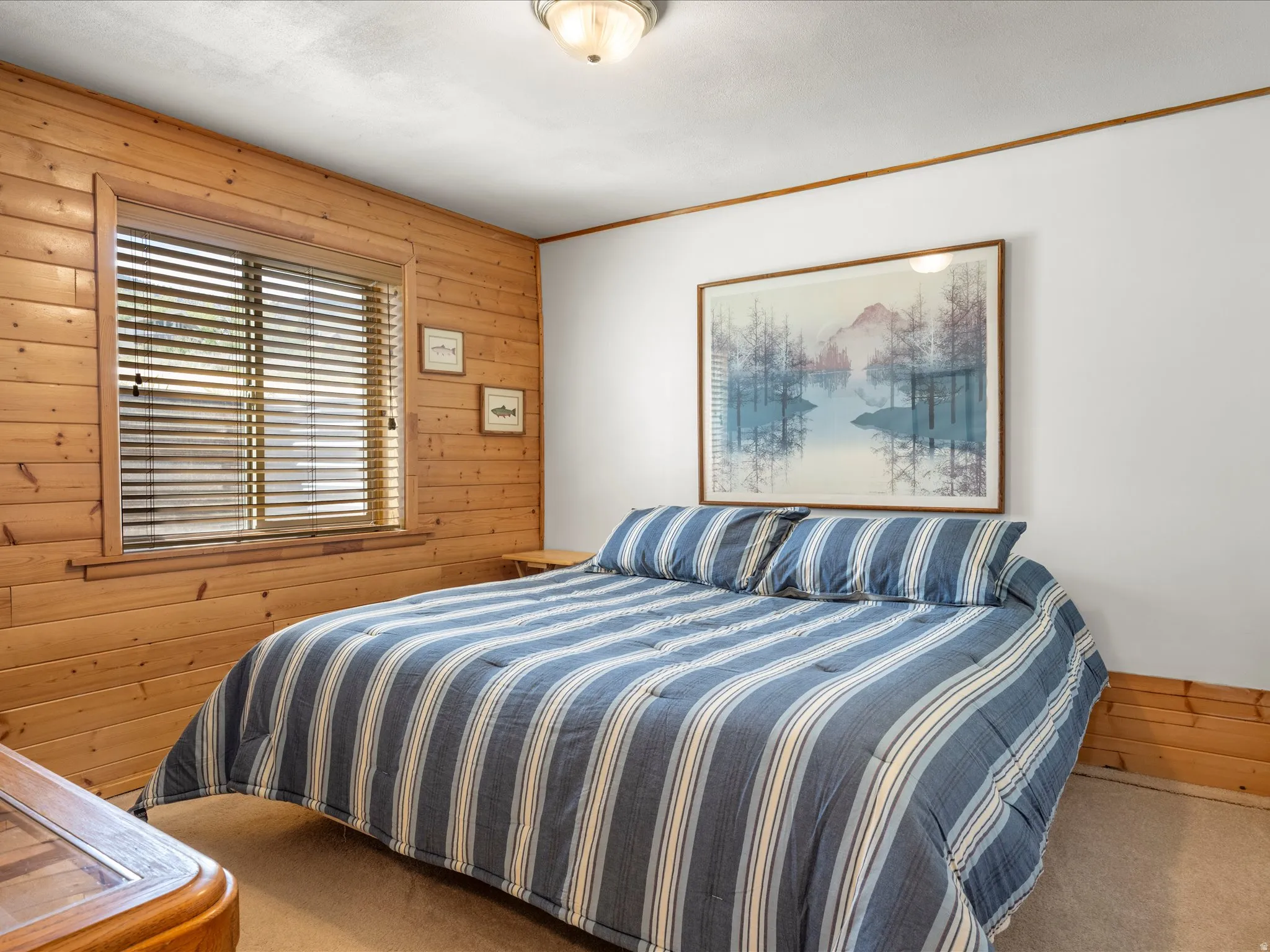 Interior room featuring natural wood paneling, white painted walls, and a ceiling-mounted light fixture