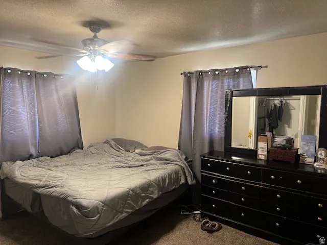 Bedroom space featuring a ceiling fan with integrated lighting