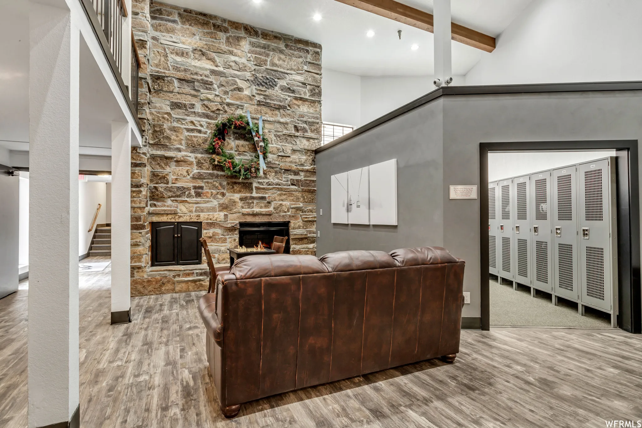 Floor-to-ceiling stone fireplace feature with a raised hearth and built-in wood storage