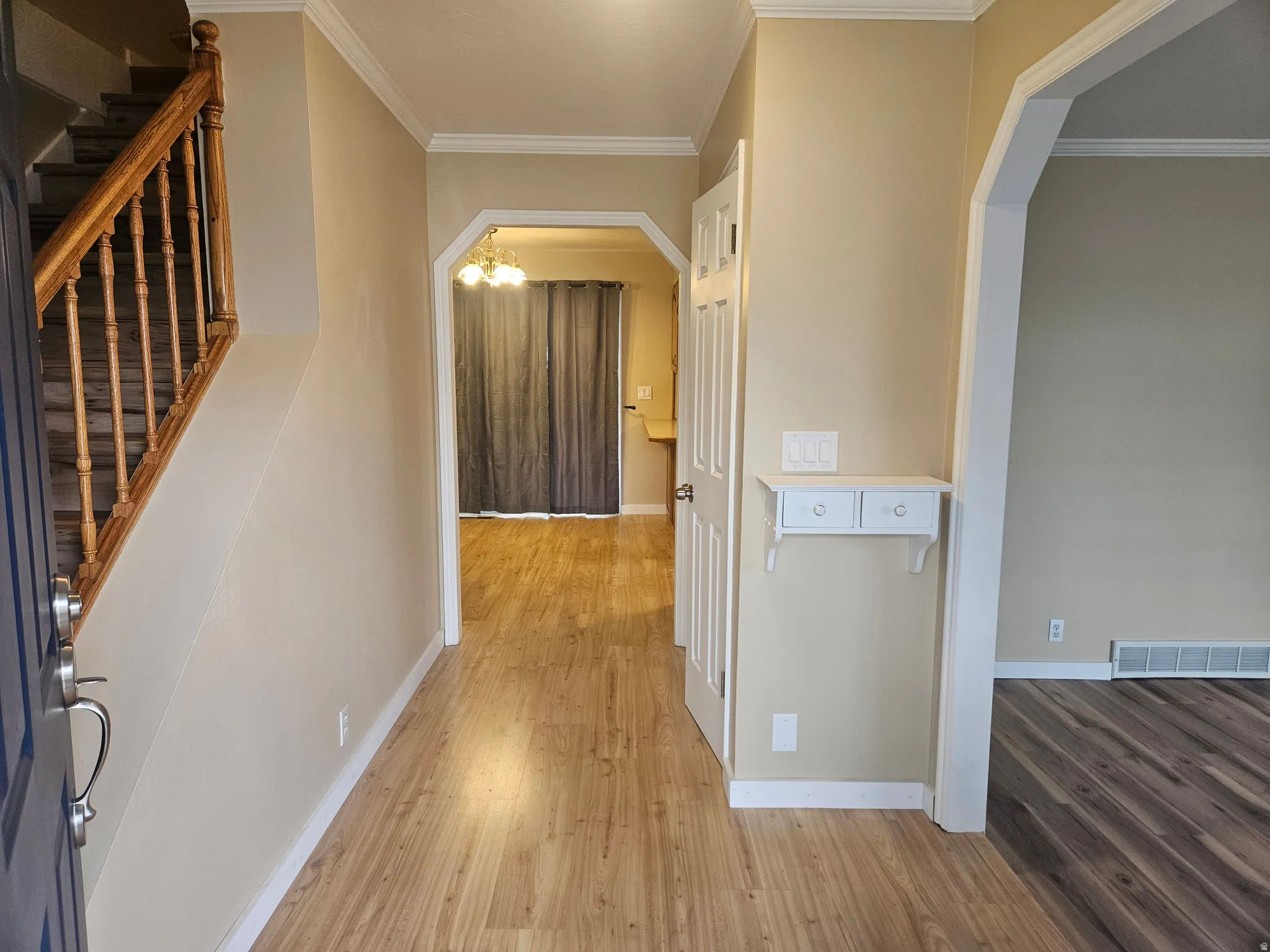 Entryway with wood-finish flooring extending into the interior