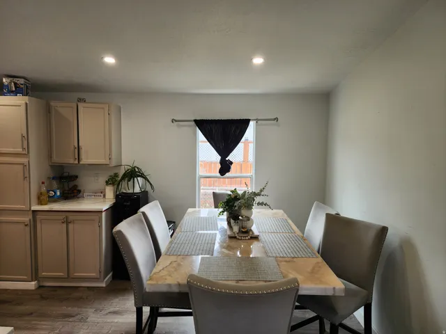 Dining area featuring recessed lighting, a window with natural light, and wood-finish flooring