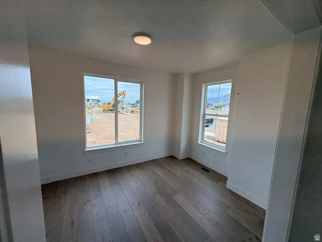 Wood-finish flooring with white walls and trim