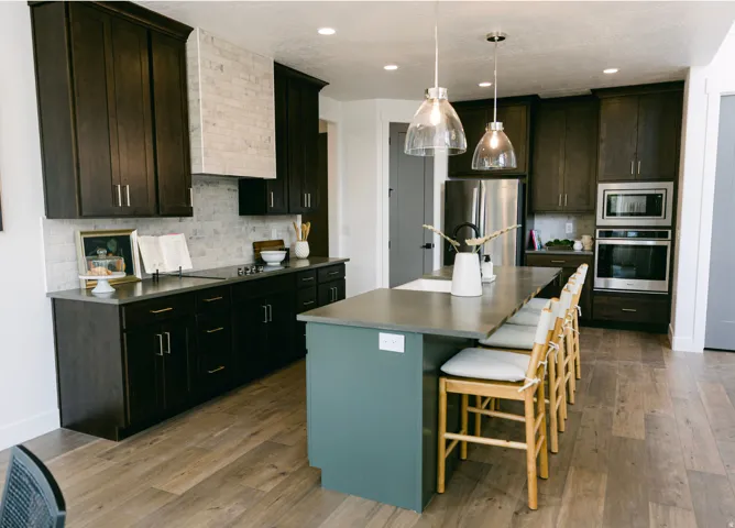 Modern kitchen featuring dark wood-finish cabinetry, stainless steel appliances, and wood-finish flooring