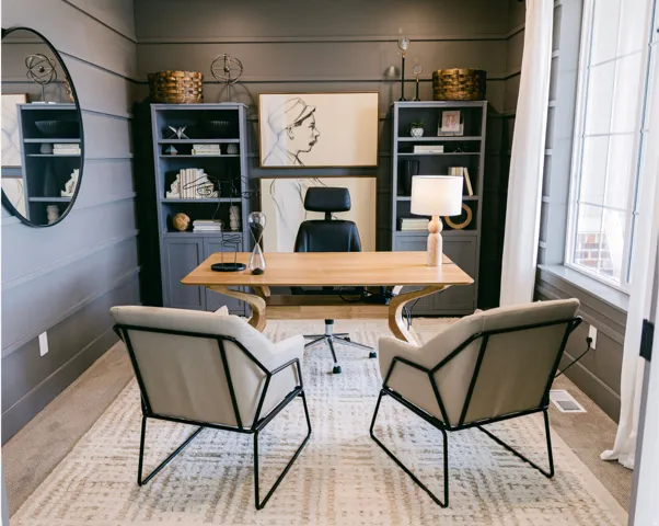 Spacious interior room featuring wainscoting, built-in shelving, a large window, and carpeted flooring