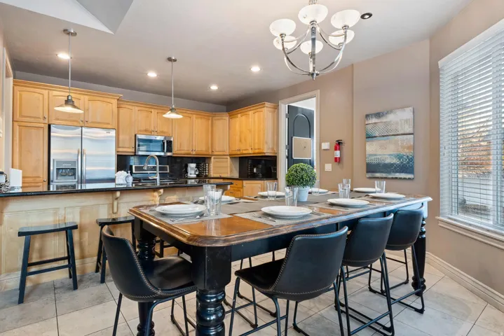 Kitchen featuring wood cabinetry, stainless steel appliances, and dark countertops