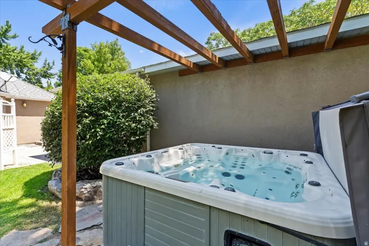 Outdoor spa set within a pergola structure