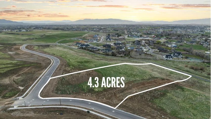 Expansive 4.3-acre parcel featuring gently sloping terrain and paved road frontage