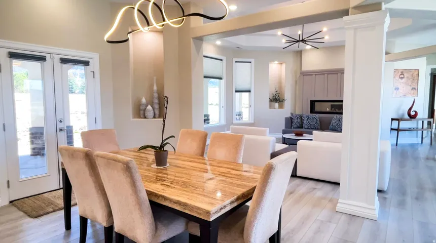 Dining area featuring a contemporary chandelier, wood-finish flooring, and double French doors to the exterior