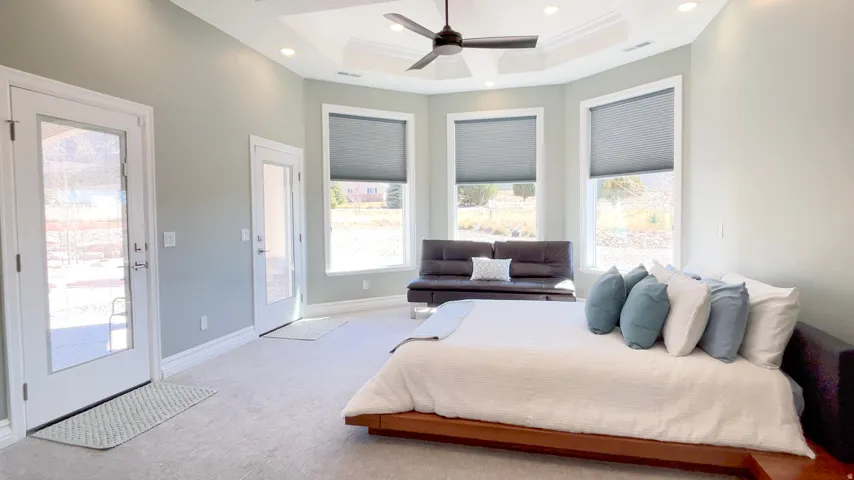 Spacious room featuring light-colored walls, recessed lighting, and a ceiling fan