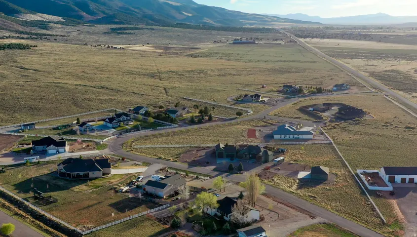 Expansive aerial perspective showcasing a residential development with multiple homes on individual lots