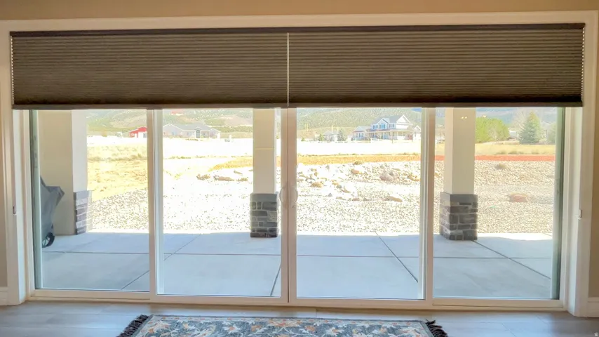 Four-panel sliding glass door with integrated cellular shades