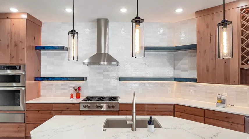 Modern kitchen featuring wood-finish cabinetry, stainless steel appliances, and a gas range