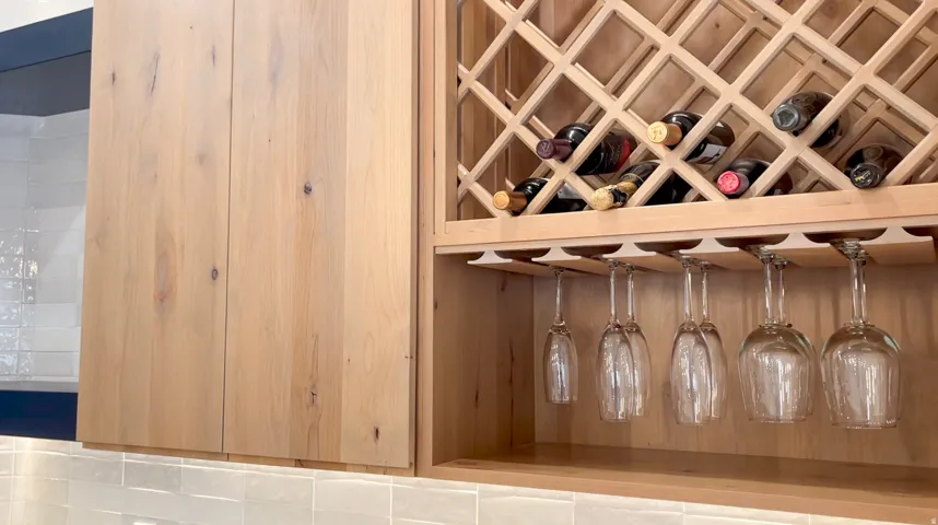 Custom wood-finish cabinetry featuring integrated wine storage and stemware racks