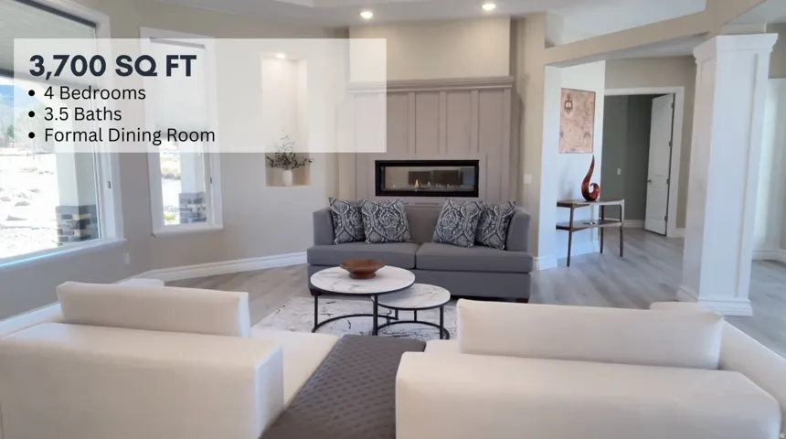 Spacious living area featuring light wood-finish flooring, recessed lighting, and large windows