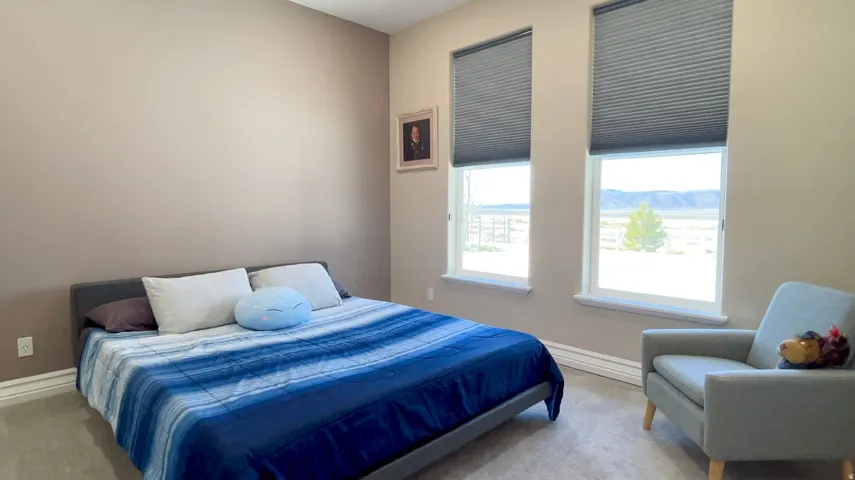 Light tan walls complement the neutral carpeting and white baseboards