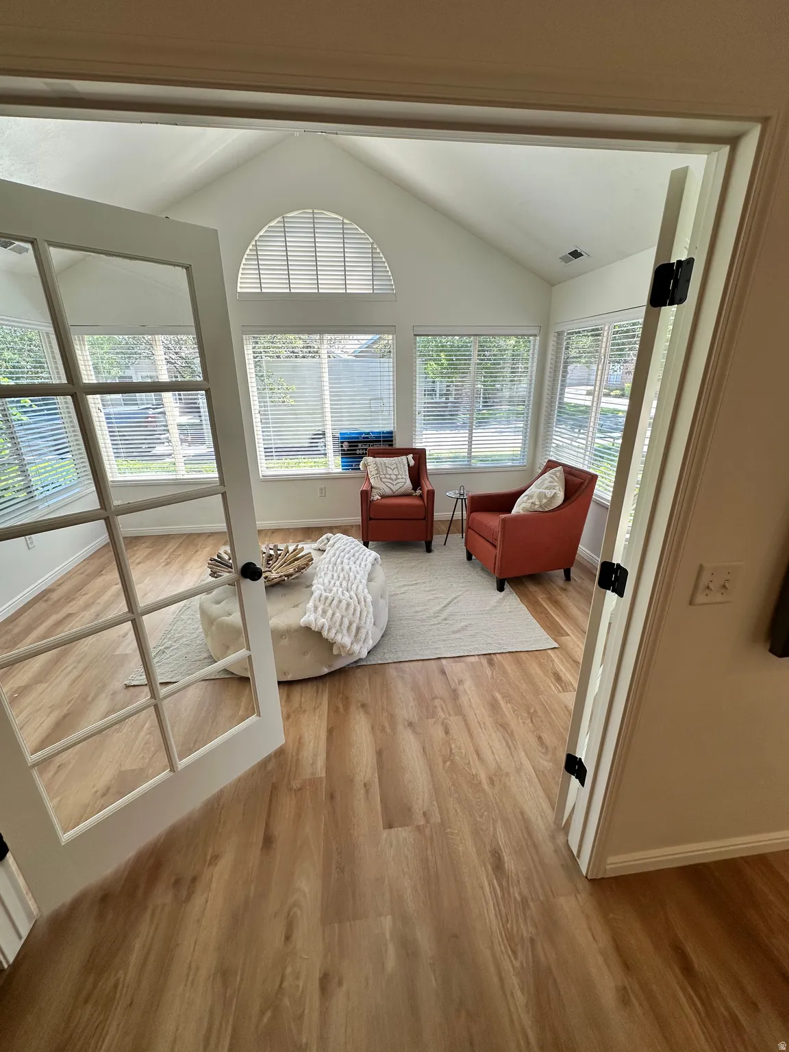 Sunroom featuring vaulted ceilings and abundant natural light
