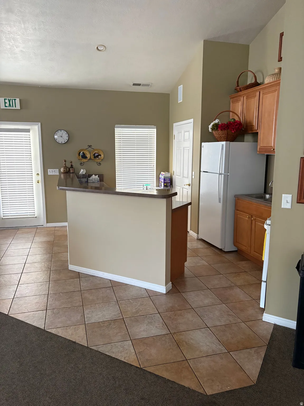 Clubhouse, Kitchenette featuring light wood cabinetry, a built-in sink, and a refrigerator