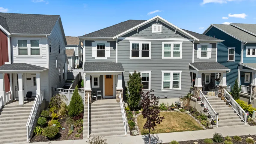 Contemporary gray siding exterior with white window shutters and trim