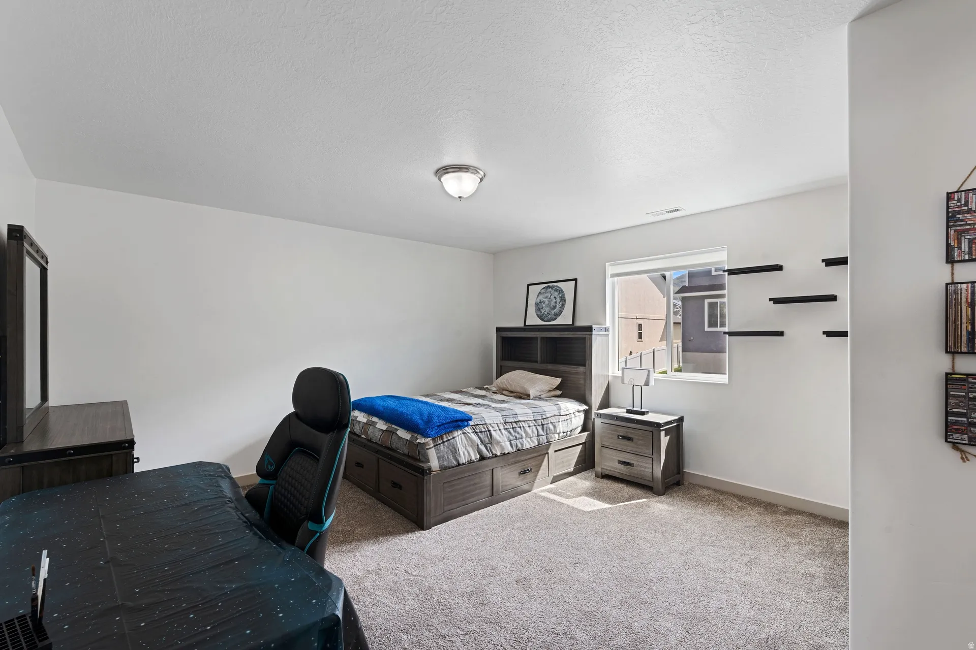 Carpeted interior space featuring white walls and a single window with white trim