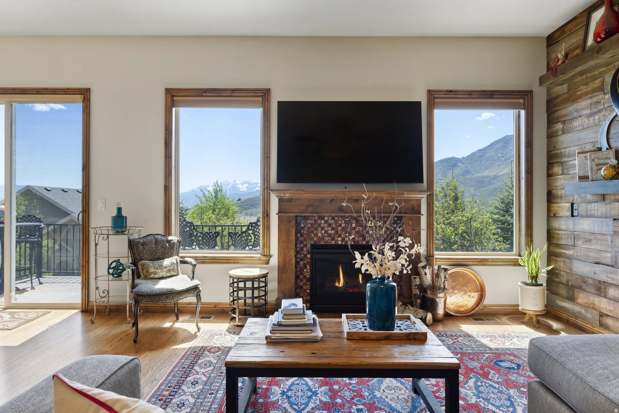 Living area featuring hardwood flooring and a fireplace with a tiled surround