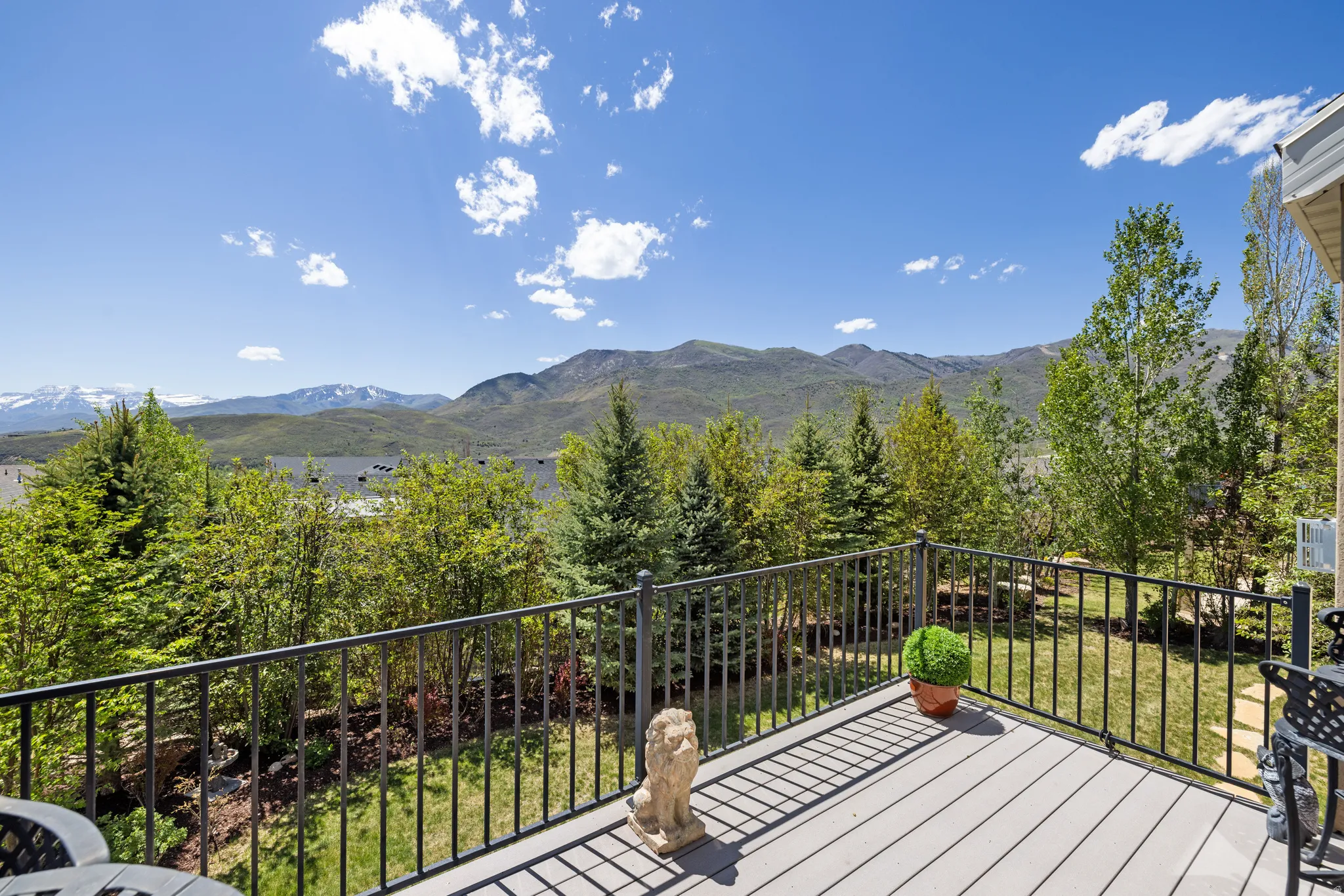 Outdoor deck featuring composite decking and black metal railings