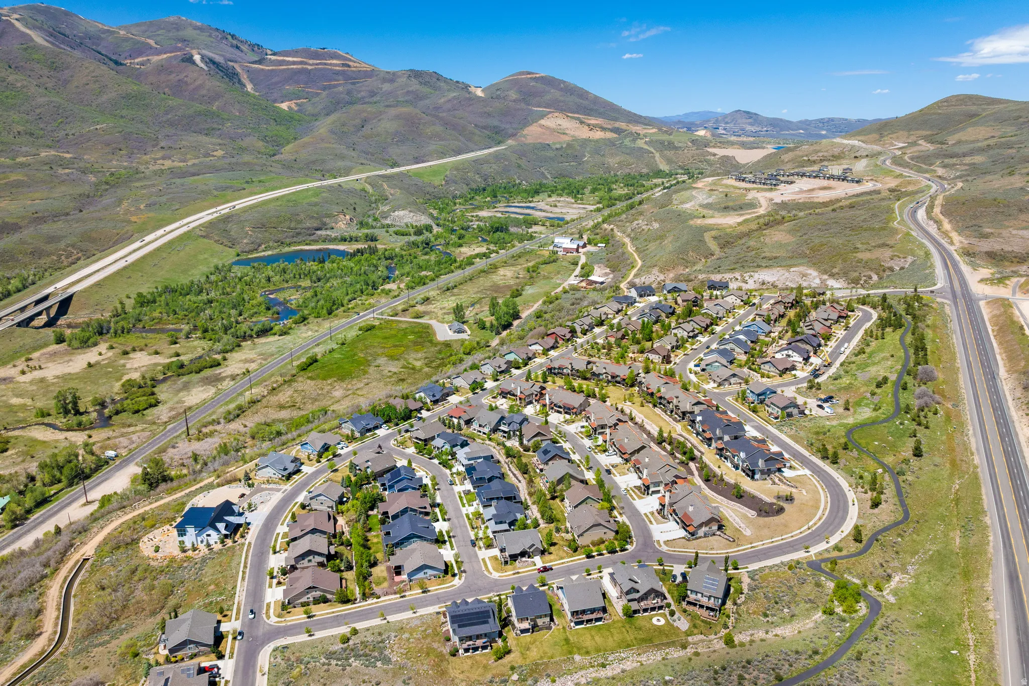 Aerial perspective showcasing a residential community nestled in a mountainous landscape