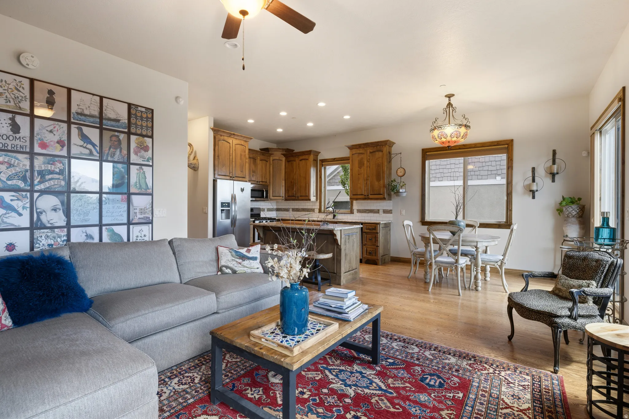 Open-concept living space featuring wood-finish flooring, recessed lighting, and a ceiling fan