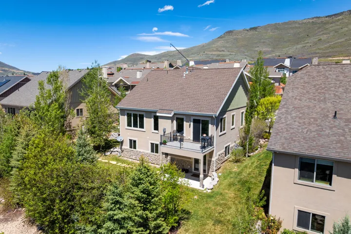 Multi-level residence featuring a stucco exterior and stone accents