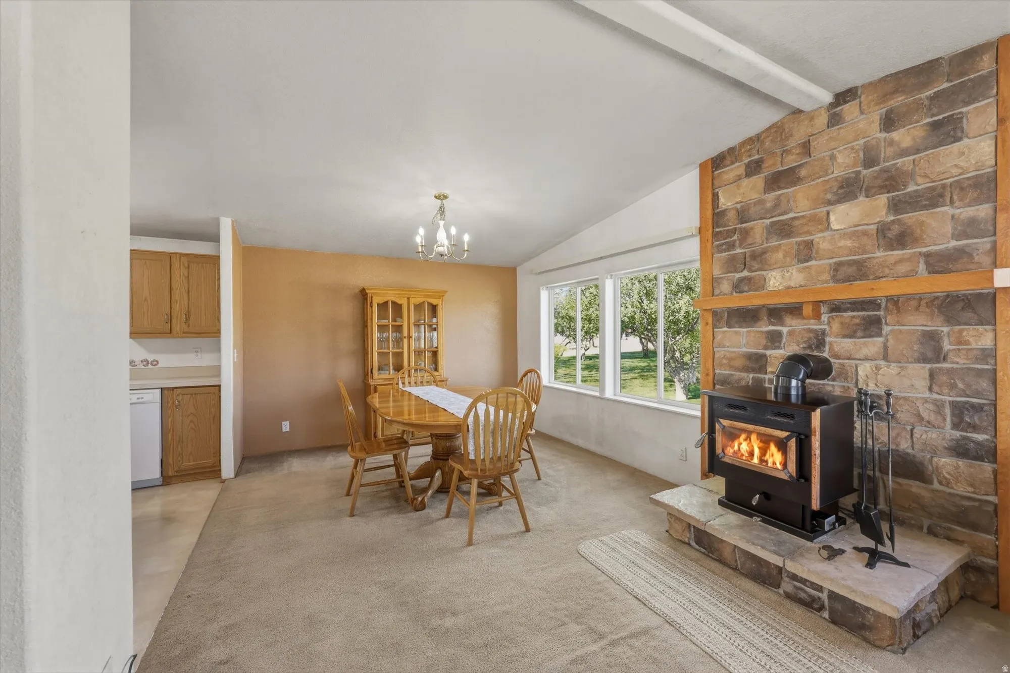 Stone-clad fireplace with a wood-burning stove and hearth
