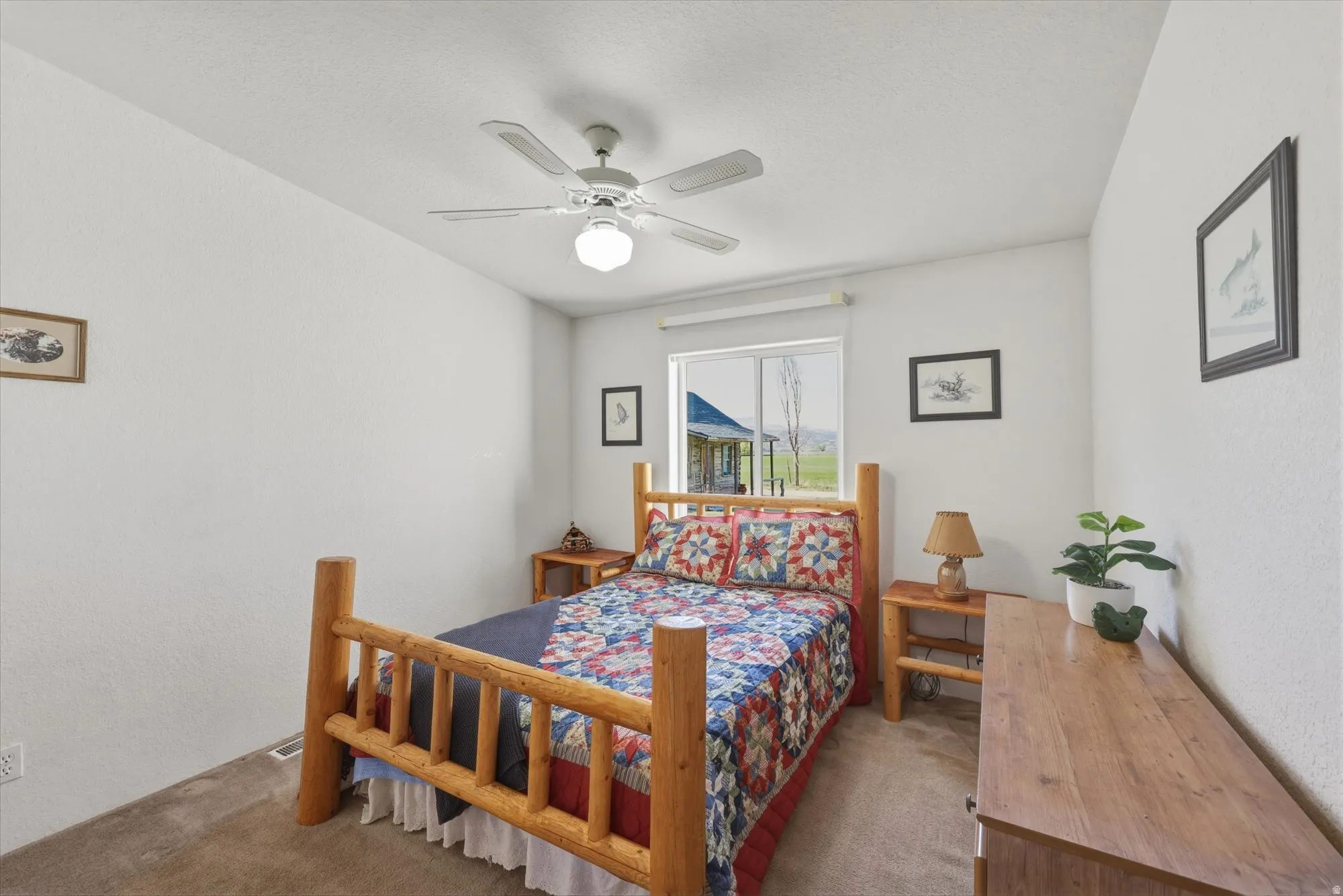 Carpeted bedroom with a window offering exterior views