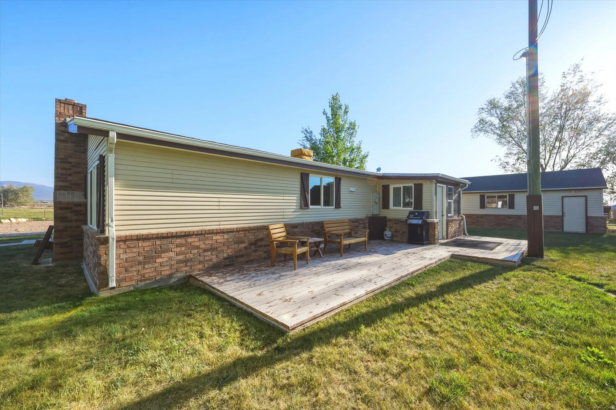 Exterior showcasing a light-colored siding and brick-patterned wainscoting