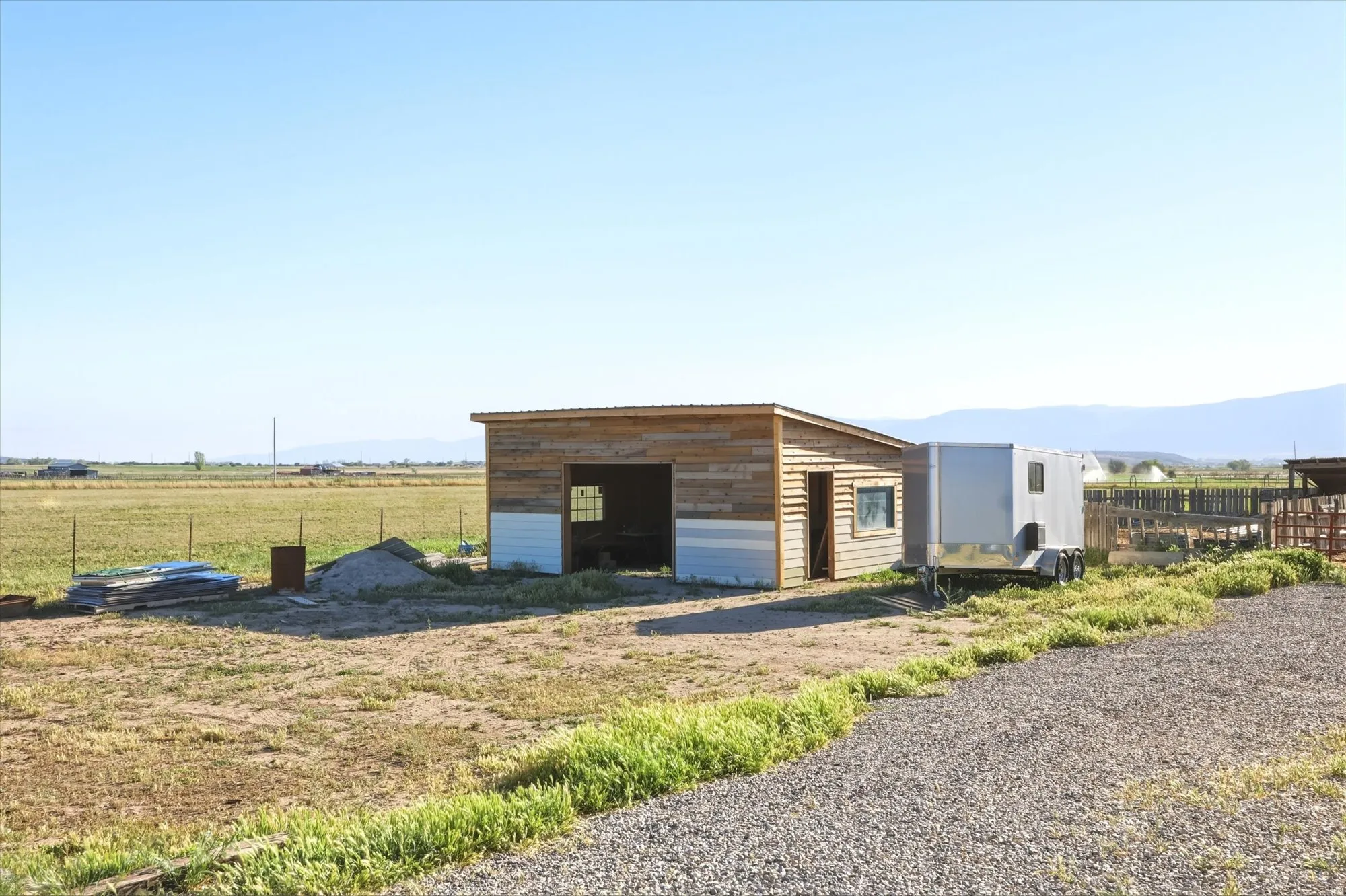Outbuilding with wood siding and a single-pitch roof
