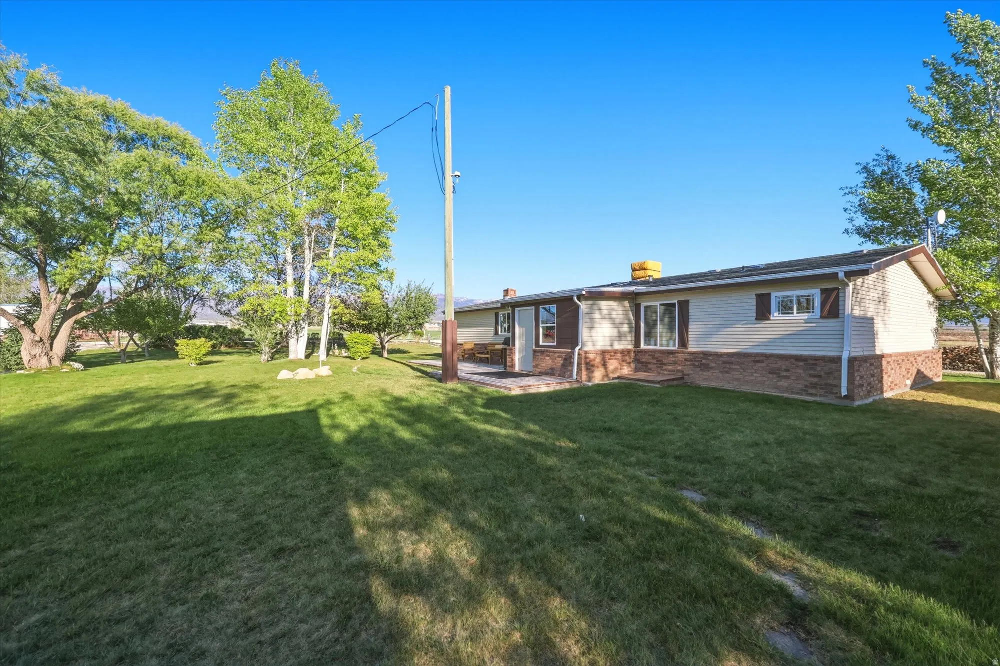 Expansive exterior featuring a combination of horizontal siding and stone veneer
