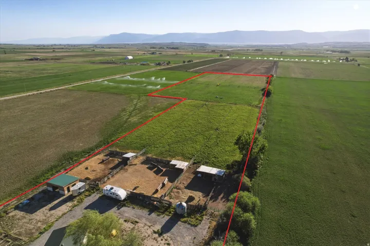 Aerial view of expansive agricultural property outlined by a red boundary