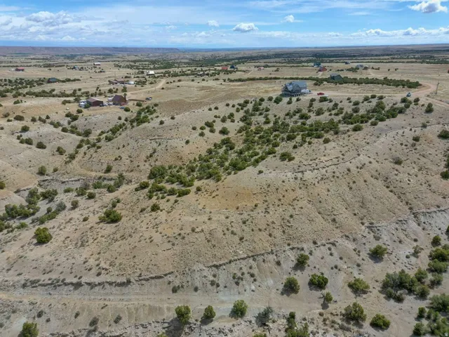 Expansive undeveloped land featuring varied terrain and natural vegetation, offering a secluded setting