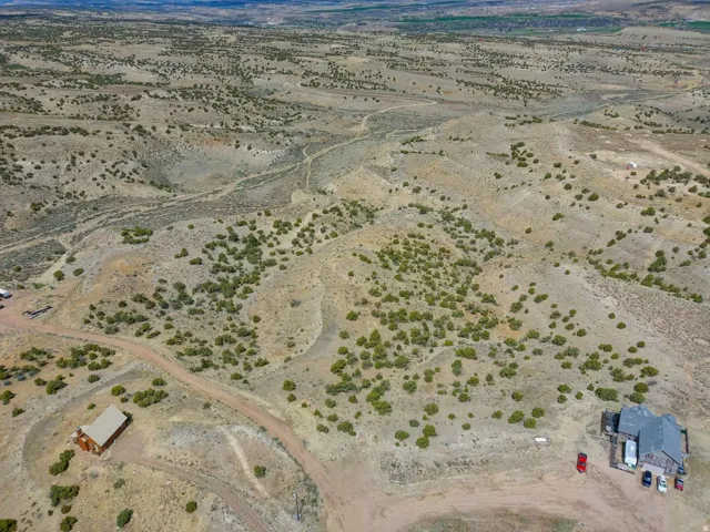 Expansive desert landscape featuring rolling hills and sparse vegetation