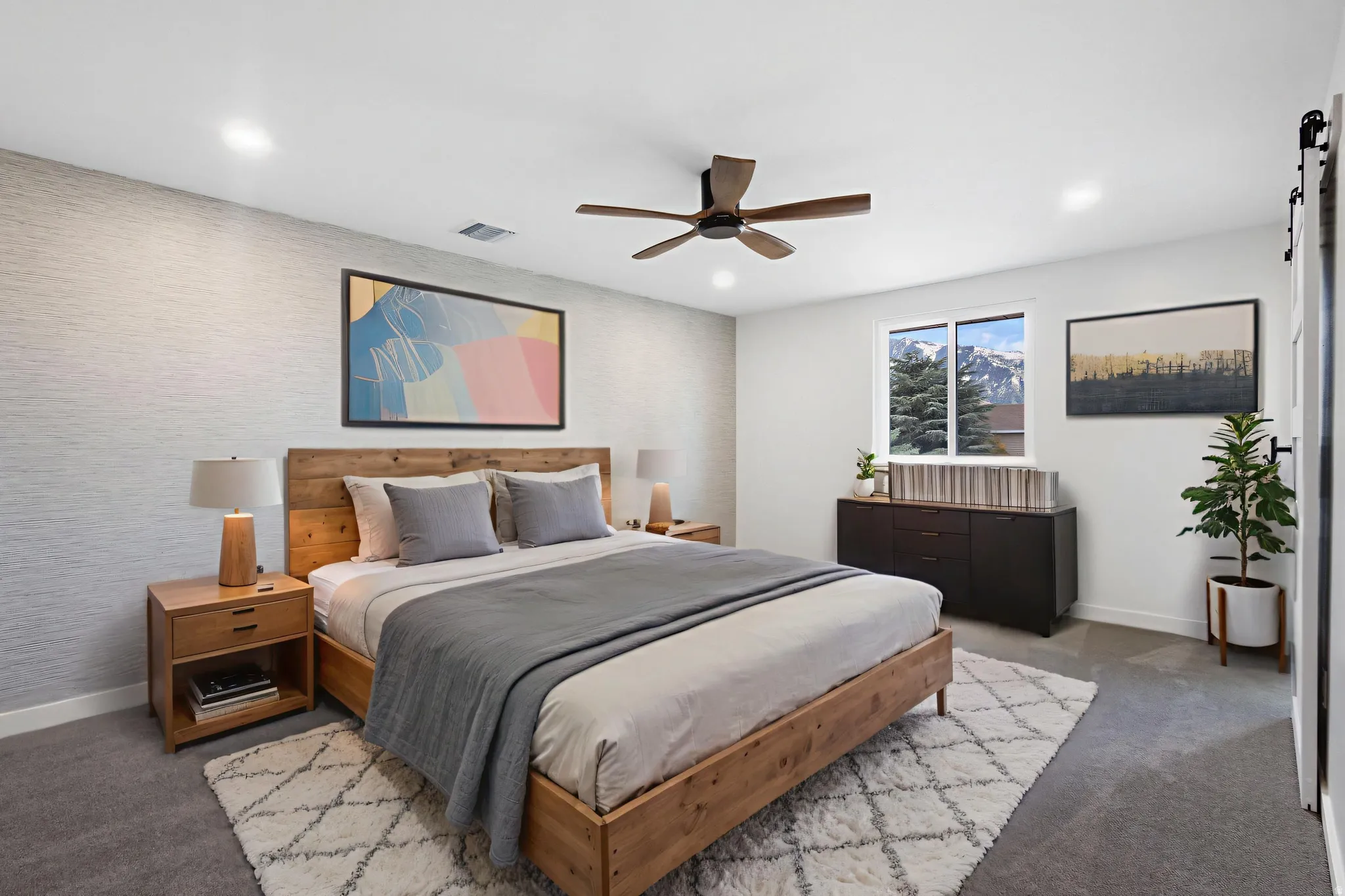 Bedroom featuring textured accent wall, recessed lighting, and a ceiling fan
