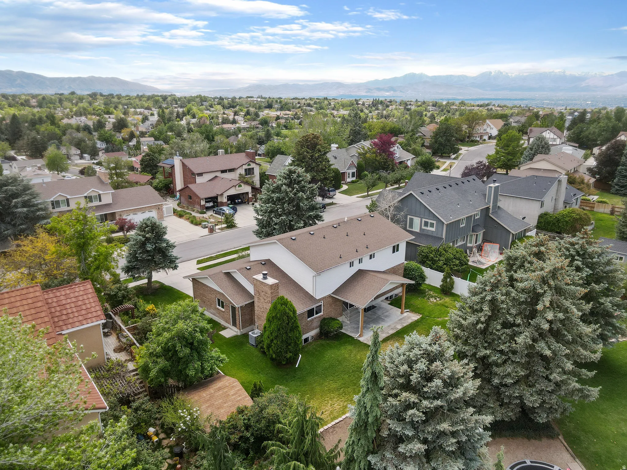 Aerial perspective showcasing a residential neighborhood with surrounding mountains